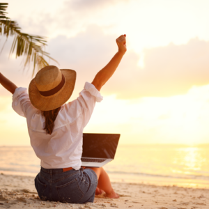 Entrepreneur sitting in retreat setting overlooking ocean, reconnecting with clarity and creativity